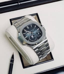 This is a Patek Philippe Nautilus Moon Phase Power Reserve 5712/1A-001 in stainless steel with a blue dia